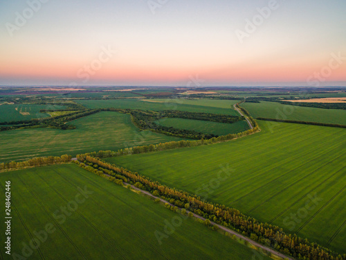 Aerial drone view, at sunset on the river among the fields. The middle band of Russia