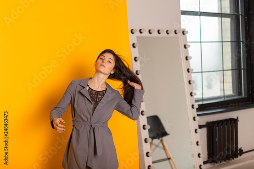 beautiful and sexy woman wearing a gray suit with a stylish women's jackets and pants. Conception of business woman, student, young business lady. photo