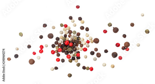 Heap of black, red, white and allspice peppercorns isolated on white background, top view