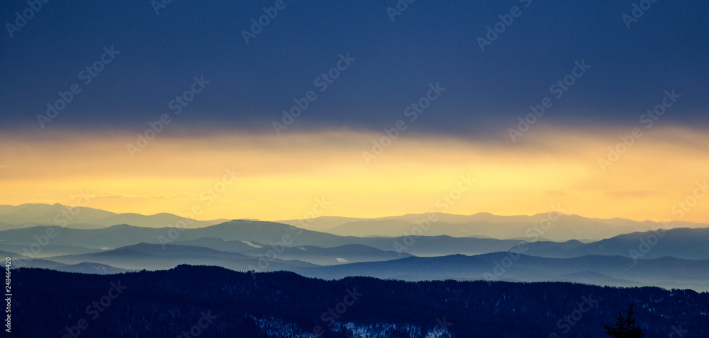 Panorama of mountain peaks in Sheregesh at dawn from Mount Zelenaya.
