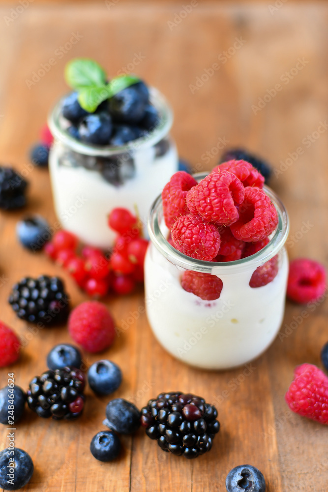 diet breakfast or lunch : organic yogurt with fresh berries of blackberries, raspberries, blueberries, red currants. the concept of a healthy lifestyle, diet food. selective focus and copy space