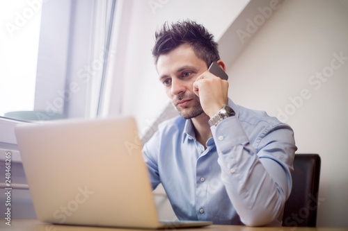 Young businessman using mob...