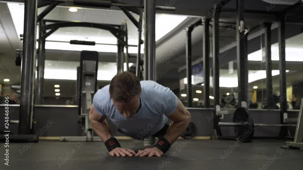 Image of an attractive man doing push-up at the gym. Image of an attractive man doing push-up at the gym.