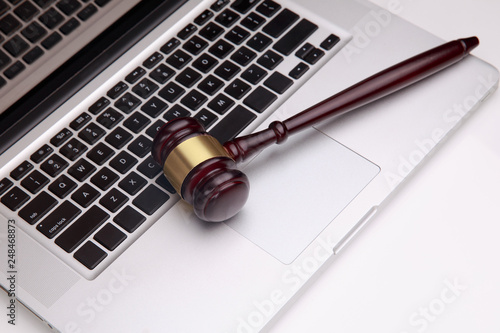 gavel on white laptop. Concept -online Auction photo