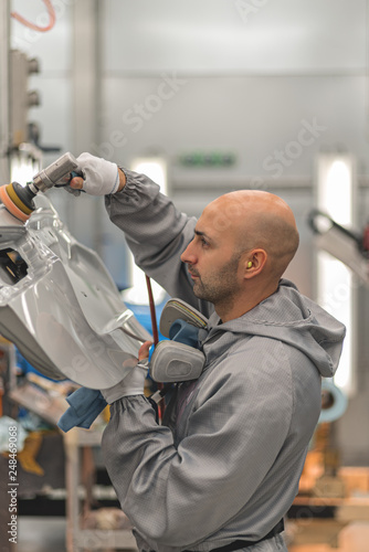 Wallpaper Mural Employee in the shop painting the car body polishes painted body parts Torontodigital.ca