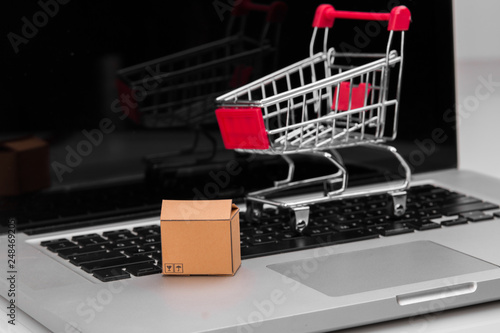 Boxes in and trolley on a laptop online shopping is a form of electronic commerce that allows consumers to directly buy goods from a seller over the internet.