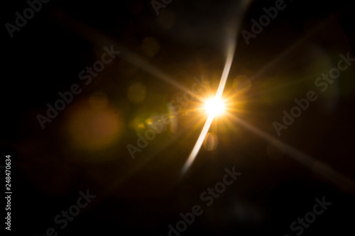 Abstract Natural Sun flare on the black background. photo
