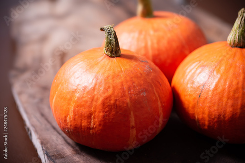 Orange pumpkins on wooden background