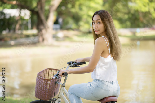 woman riding bicycle in park