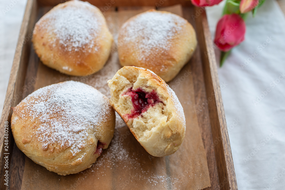 German donuts - krapfen or berliner - filled with jam