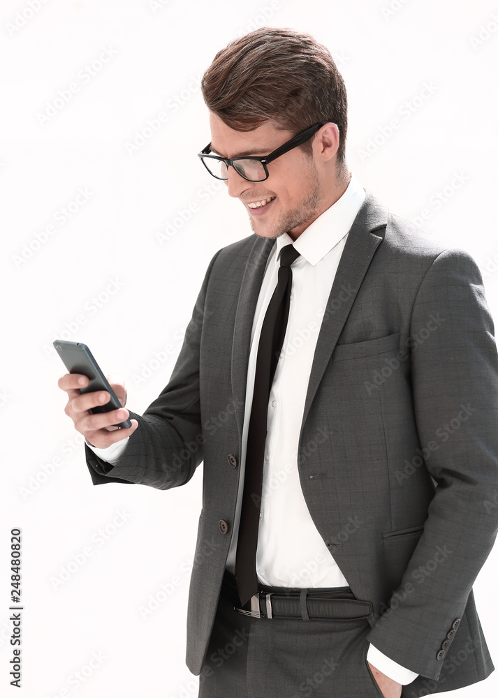 smiling businessman looking at the screen of his smartphone smiling businessman looking at the screen of his smartphone