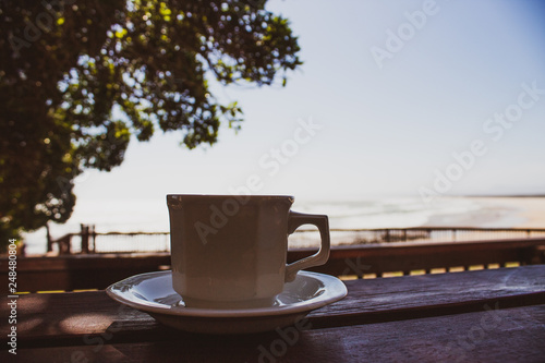 Beach house life: coffee cup with scenic ocean view. Good morning, South Africa!