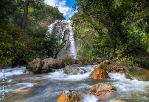 Khlong Lan Waterfall water flowing over rocks coastline. 