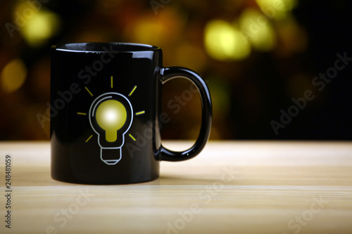 tea mug bulb symbol wooden table 