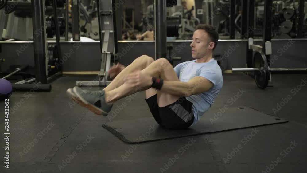 Image of a muscular man doing abdominal exercise at the gym. Image of a muscular man doing abdominal exercise at the gym.