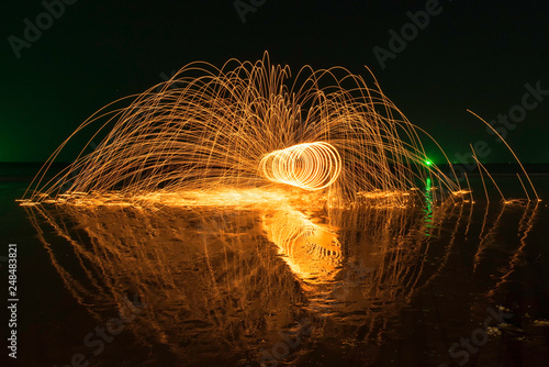 Amazing Fire dancing steel wool and lamp in the night.