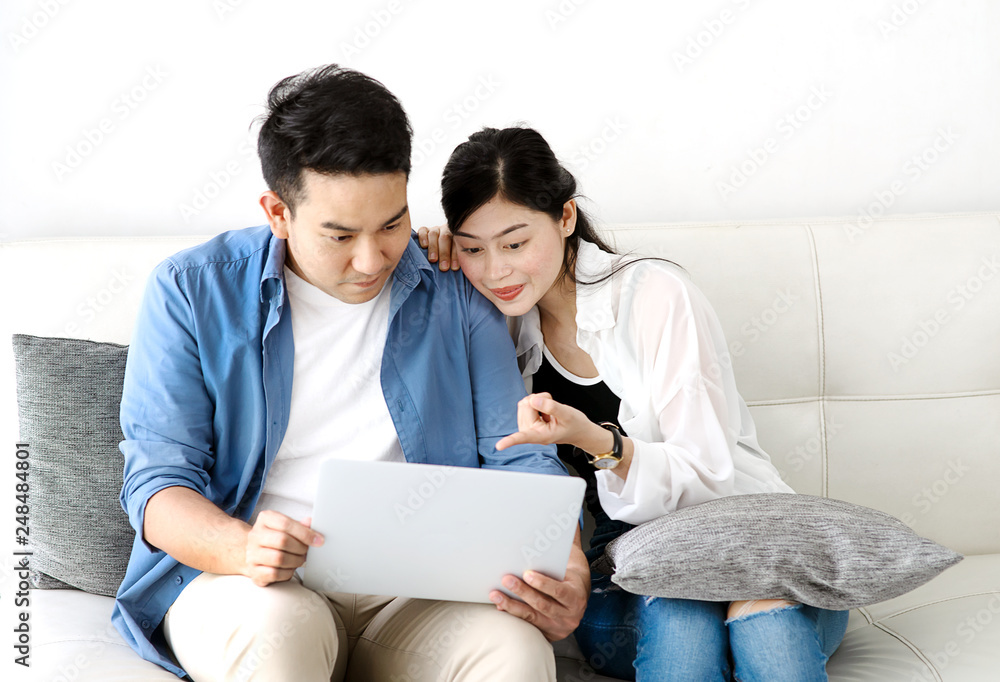 Happy Asian couple using laptop at home, lifestyle concept. Happy Asian couple using laptop at home, lifestyle concept.