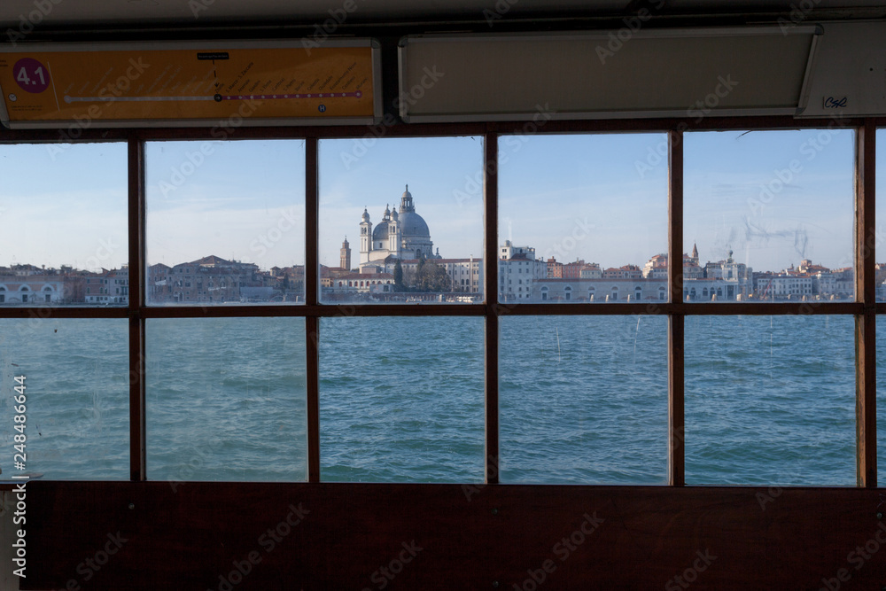 Waiting the ferry boat on the Giudecca. View of the Canal Grande and the Gesuati church from the pier window