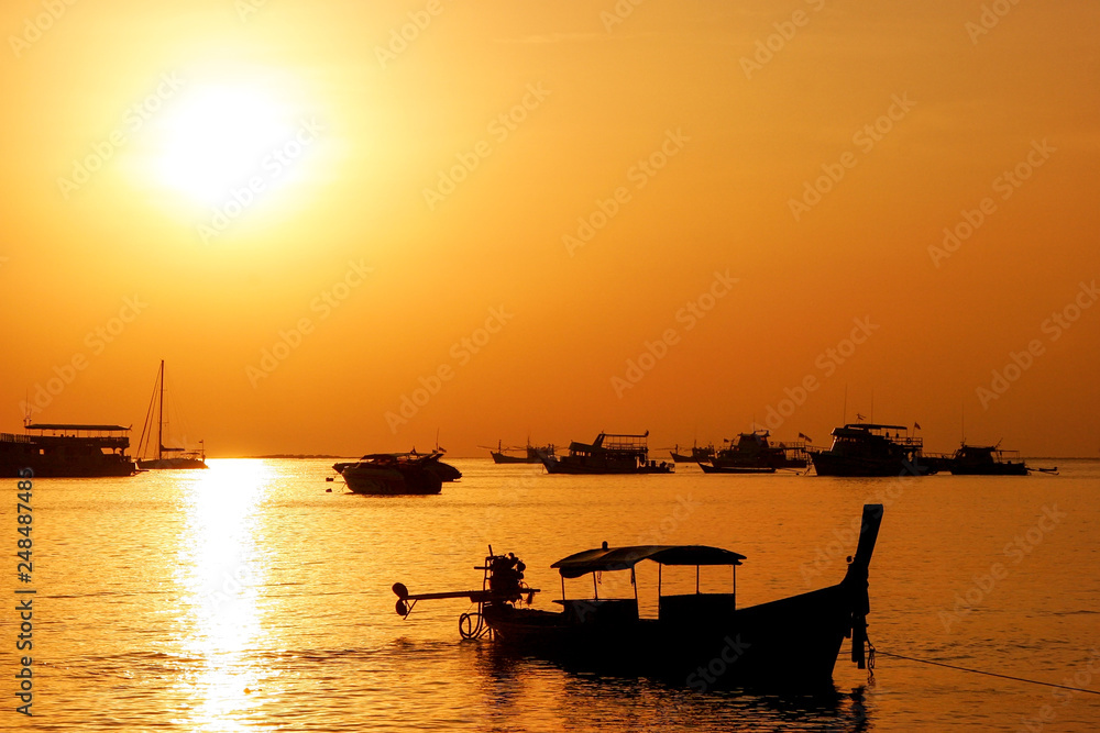 Silhouetted longtail boat at sunrise on Ao Ton Sai, Phi Phi Don Island, Krabi Province, Thailand