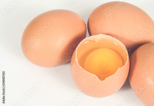 Fresh and Raw chicken eggs in egg on white background.