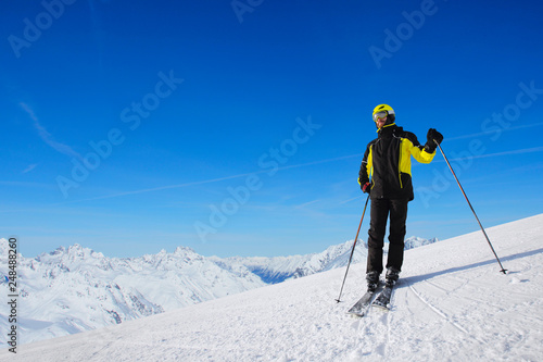 Skier standing on mountain slope