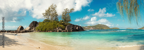 A stunning wide panoramic large format photograph of The stunning Anse royal beach in the seychelles, island of mahe. Paradise and beautiful blue sky.