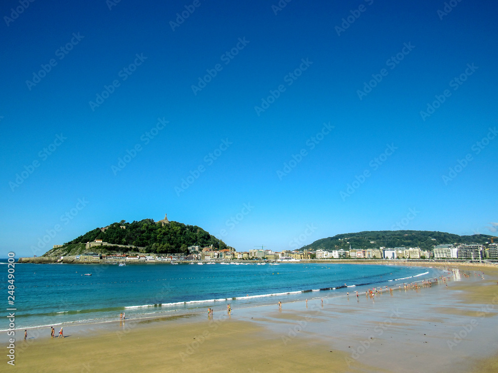 Landscape from the sunny main beach of San Sebastian, along the coastal Camino de Santiago, Northern Saint James Way