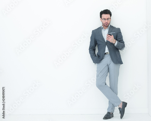 full height .business man looking at the screen of his smartphone © ASDF