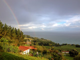 Epic rainbow falling into the sea from the hills of the Pais Basco, along the coastal Camino de Santiago