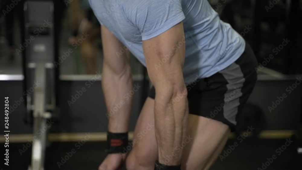 Close up image of man doing exercise with elastic band at the gym. Close up image of man doing exercise with elastic band at the gym.