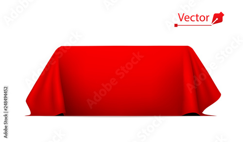 Object covered with red silk cloth. Empty podium or presentation. Secret box, hidden under satin fabric with drapery.