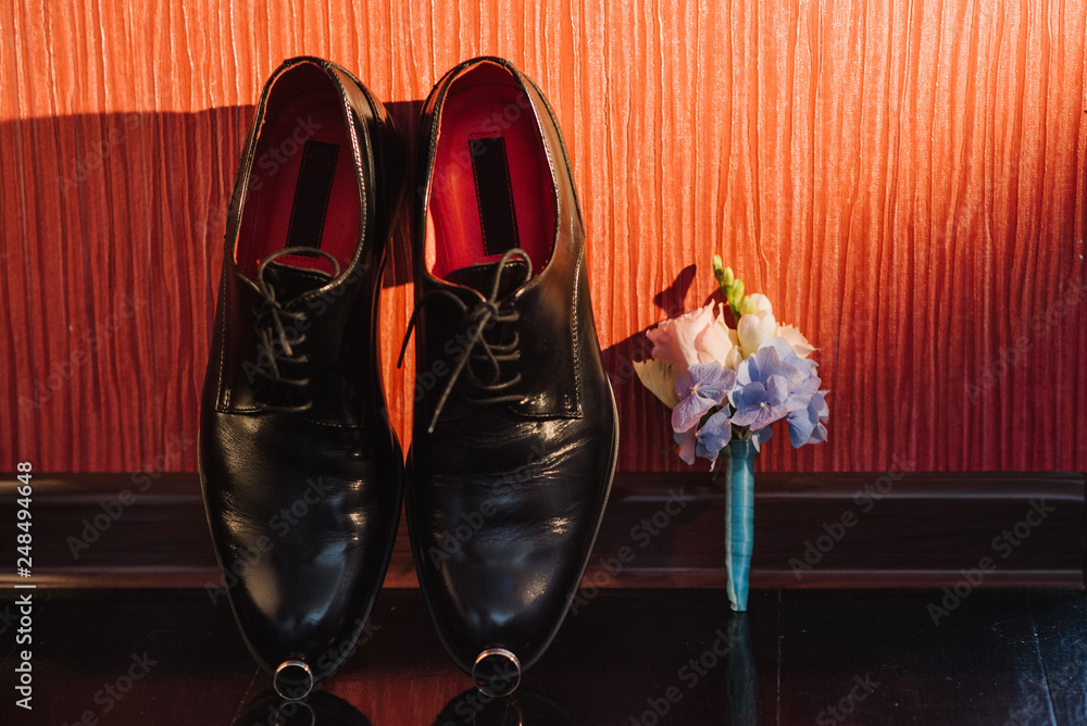 Grooms accessories for preparation on wedding day, shoes, rings and bouquet