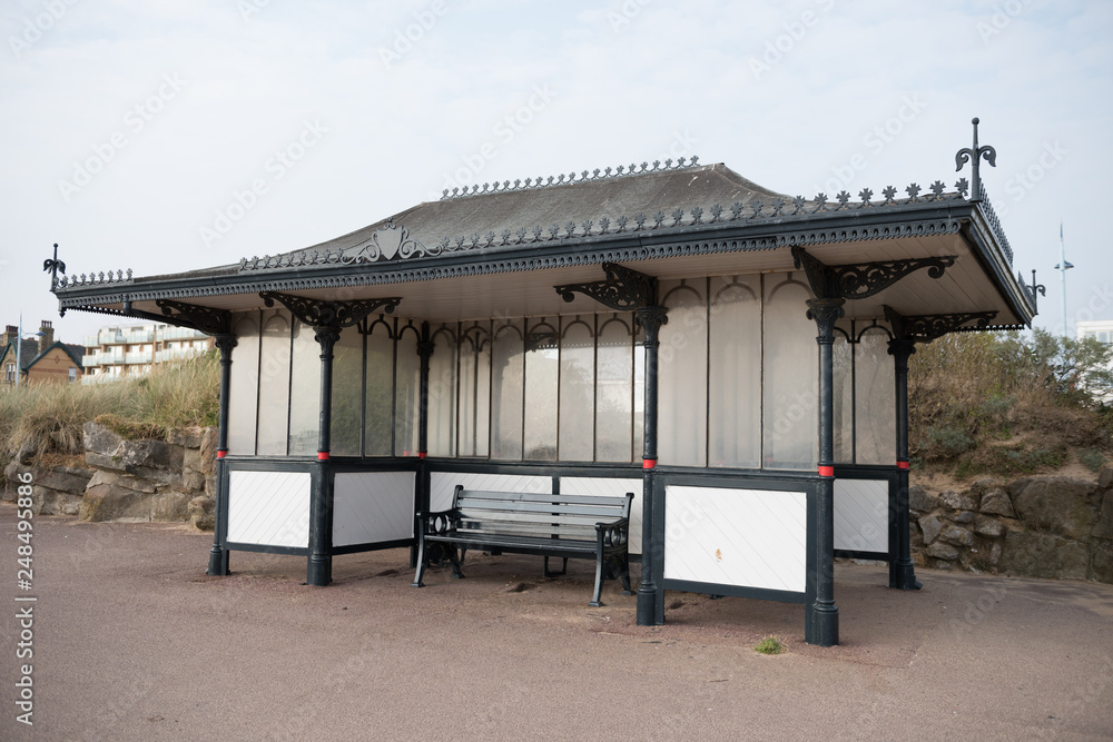 A victorian design seaside shelter on a seaside promenade. vintage retro architecture. Victorian era england building shelter.. A victorian design seaside shelter on a seaside promenade. vintage retro architecture. Victorian era england building shelter..
