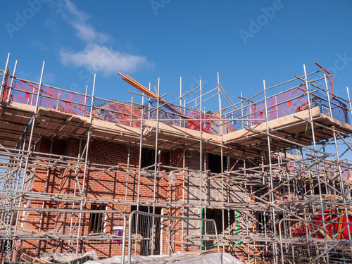 Houses in scaffolding and under construction in Cheshire England UK