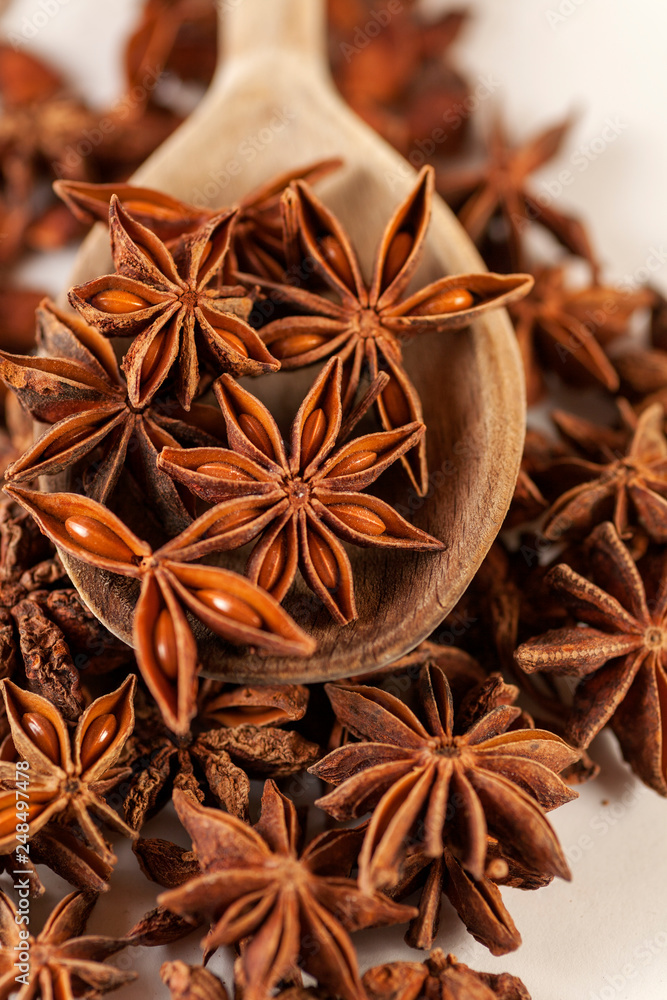 star anise on a wooden spoon star anise on a wooden spoon