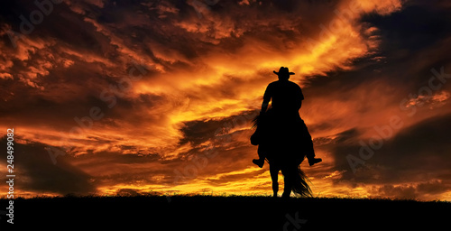 Cowboy on a horse at sunset