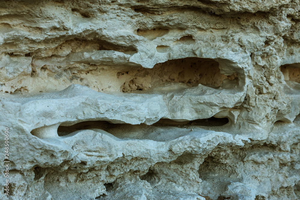 Picturesque background of collapsing surface of limestone rock