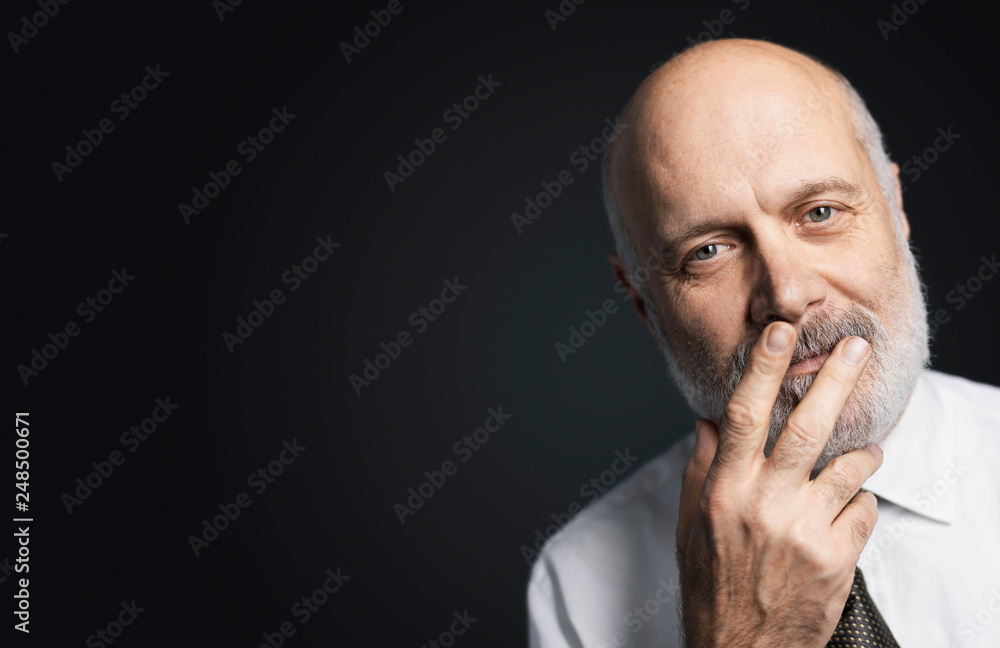 Mature man posing with a hand on his face Mature man posing with a hand on his face