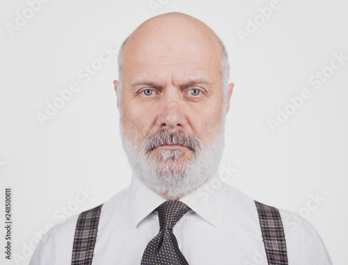 Serious businessman posing and staring at the camera © stokkete