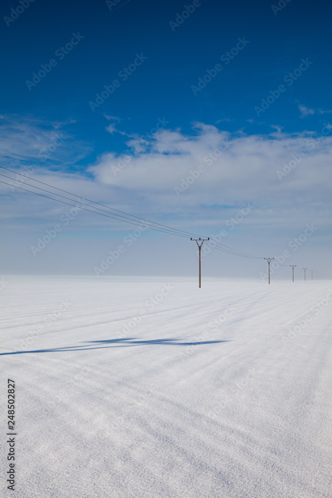 Winter landscape with power line columns a snow covered field. Winter landscape with power line columns a snow covered field.