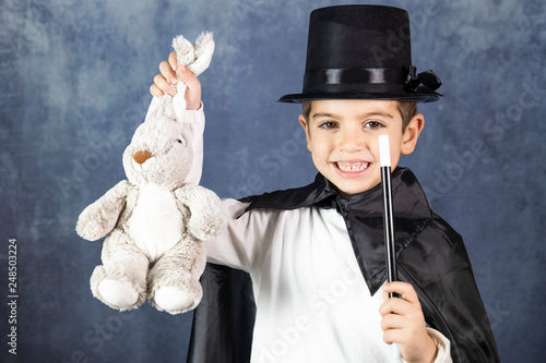 Little magician doing a trick with a rabbit