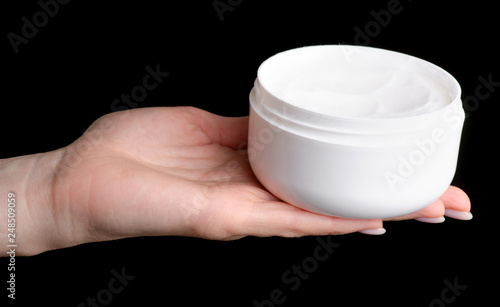 White cream container in hand beauty on black background isolation