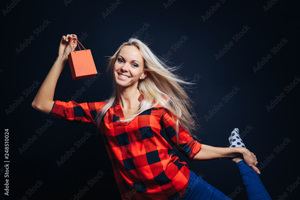 Happy smiling girl holding a small bag with a gift. Happy smiling girl holding a small bag with a gift.