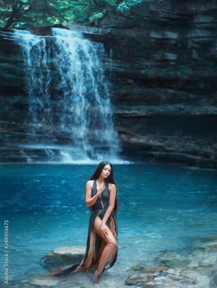 Georgia magic nature in Martvili Canyon, dark-haired sexy girl comes out of the azure transparent clear waterfall lake water, sea nymph in gorgeous green dress with deep neckline and cuts on train Georgia magic nature in Martvili Canyon, dark-haired sexy girl comes out of the azure transparent clear waterfall lake water, sea nymph in gorgeous green dress with deep neckline and cuts on train