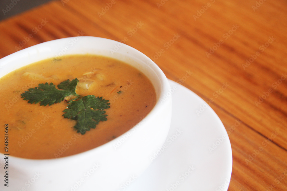 close up soup, wooden table close up soup, wooden table