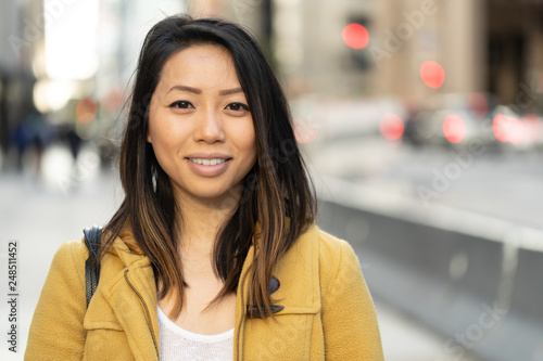 Canvas Print Young Asian woman in city smile happy face portrait