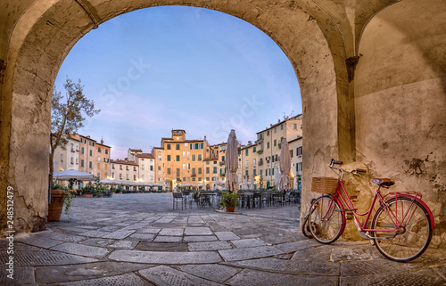 Lucca, Italy. View of Piazza dell'Anfiteatro square through the arch photo