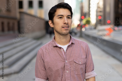 Young man in city walking street photo