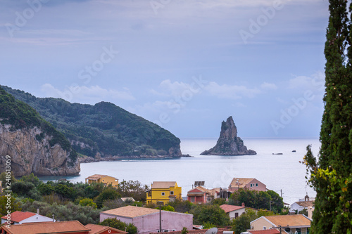 Beautiful summer seascape. View of Agios Gordios famous beach in rocky bay with crystal clear azure water on Corfu island, Ionian archipelago, Greece. photo