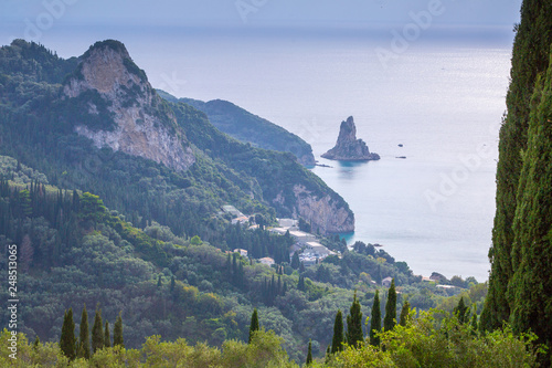 Beautiful summer panoramic seascape. View of Agios Gordios famous beach in rocky bay with crystal clear azure water on Corfu island, Ionian archipelago, Greece. photo